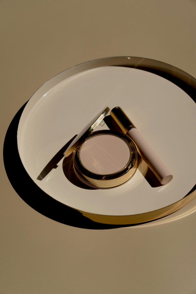 Close-up of makeup accessories on a stylish plate, showcasing modern beauty products.